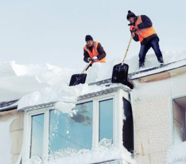 heavy snow shoveling off roof