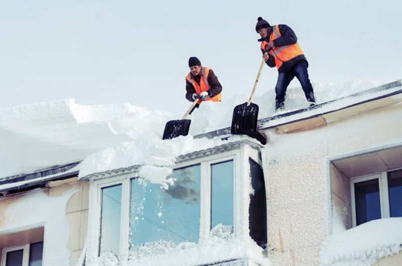 heavy snow shoveling off roof
